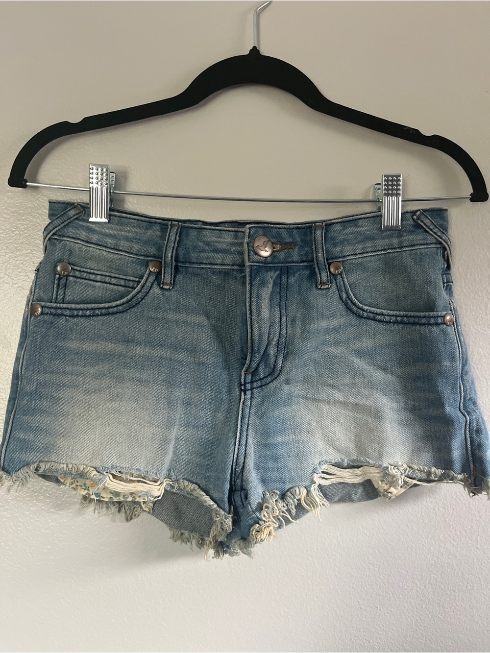 Free People distressed denim cut off low rise shorts. Size 24